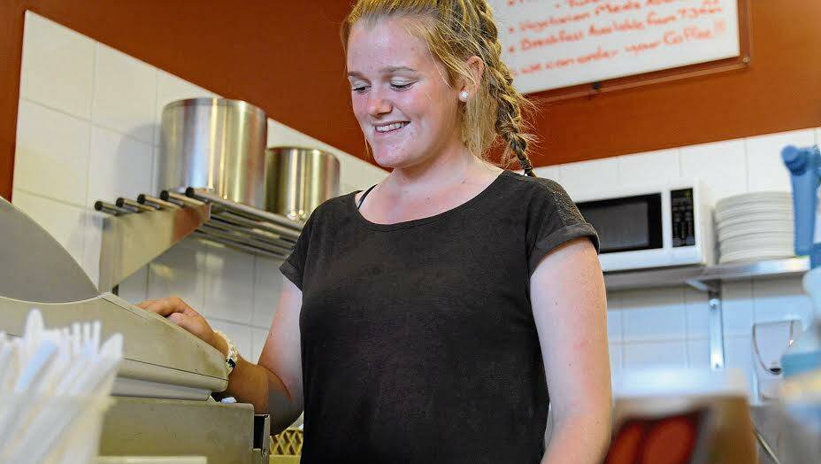 ECONOMIC CONTRIBUTION: 15-year-old Georgia Richardson works the till at the Red Jaffa cafe in Wagga. Picture: Brodie Owen