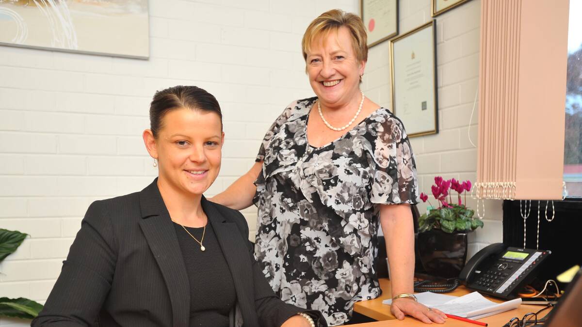 RESETTLING MIGRANTS IN WAGGA: Immigration lawyers Jessica Boatwright (sitting) and Libby Hogarth at the opening of immigration support agency, Australian Migration Options in Wagga. Ms Boatwright will head up the office. Picture: Kieren L Tilly