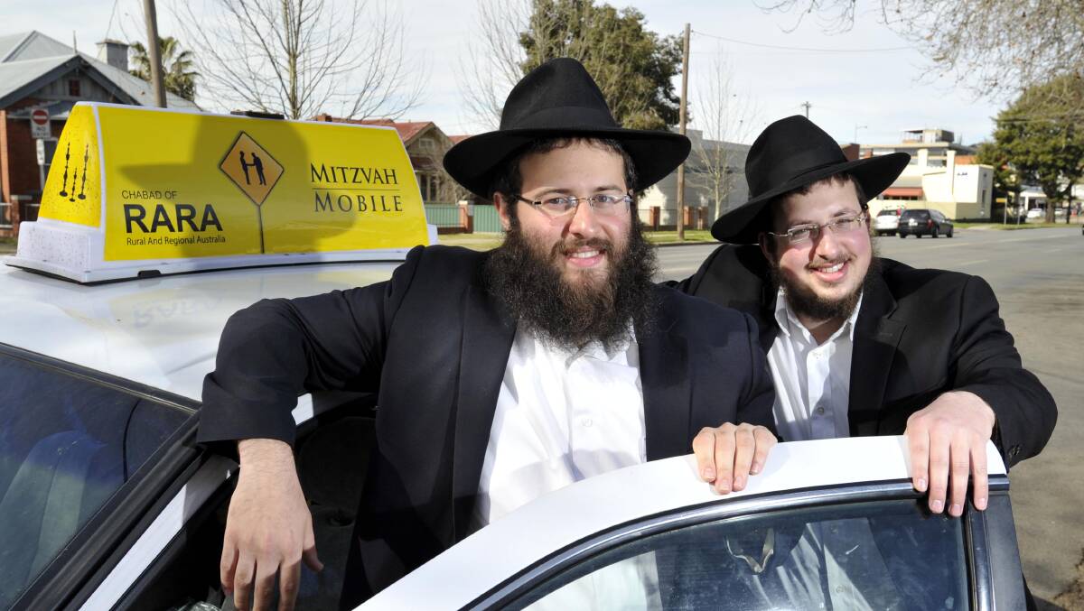 TRAVELLING SYNAGOGUE: (From left) Rabbi Srolik Winner and Rabbi Yossi Kagan passing through Wagga in their Mitzvah Mobile. Picture: Les Smith