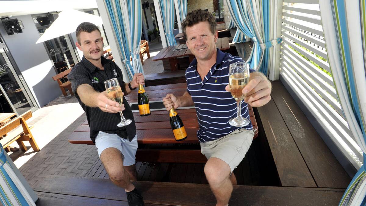 Kooringal Hotel employee Mark Hogan and owner and licensee Sean O'Hara toast their wins in the statewide Australian Hotels Association competition where they claimed best overall country hotel and best redeveloped country hotel. Picture: Les Smith
