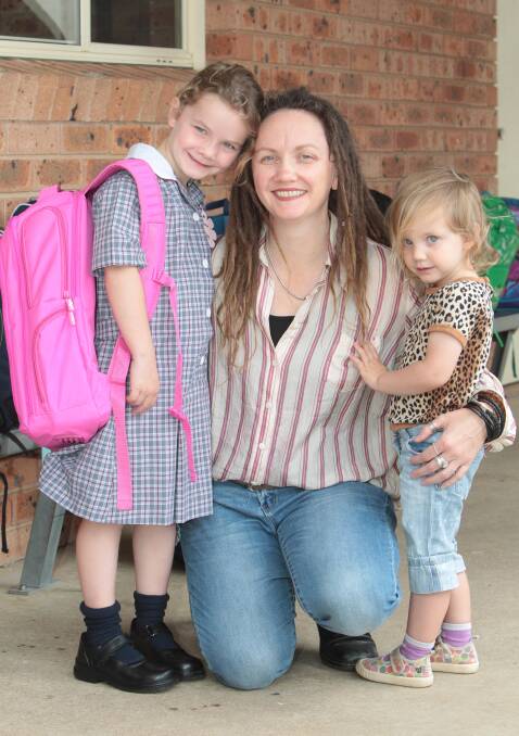 FAMILY FAREWELLS: Maeve Fleming, 5, farewells mother Therese Davis and sister Eilish Fleming, 3, on her first day of kindergarten at Wagga Christian College. Picture: Kieren L Tilly