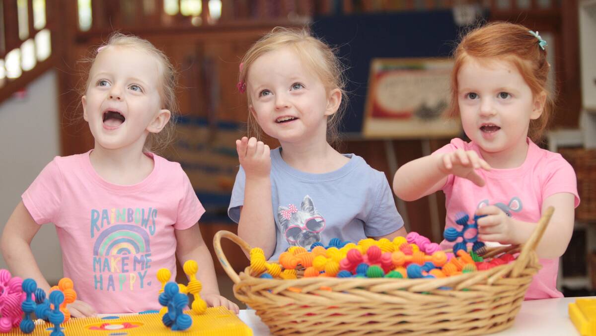Three-year-old triplets Isabella, Grace and Amelia Dunn have a ball at KU Kangaroo Preschool. Picture: Kieren L Tilly
