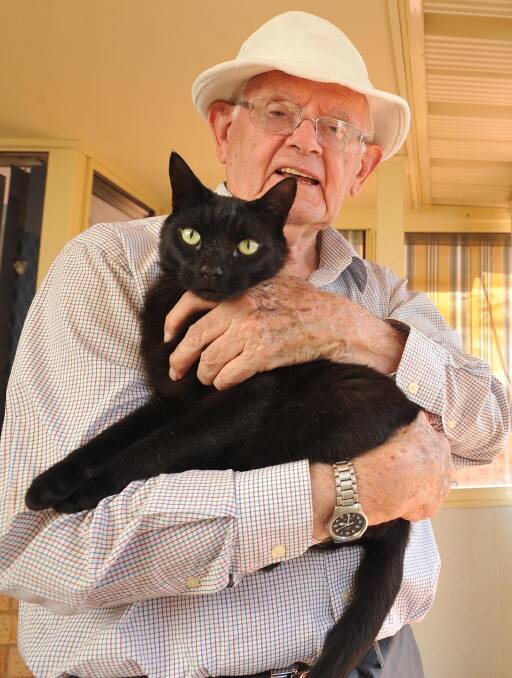 COMPANIONS REUNITED: Fr Wilf Plunkett was reunited with his five-year-old cat Sooty after he spent a month on the road returning to his former home. Picture: Laura Hardwick
