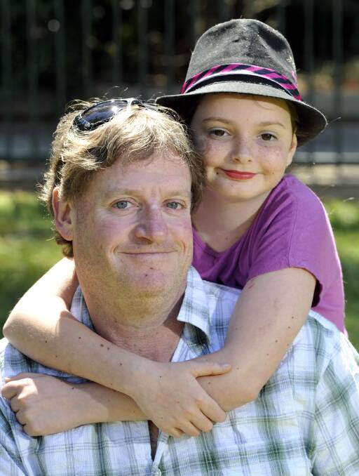 FUN IN THE SUN: Jayne Howard, 10, and father Steven Howard at the Wagga Base Hospital children's Christmas party. Picture: Les Smith 