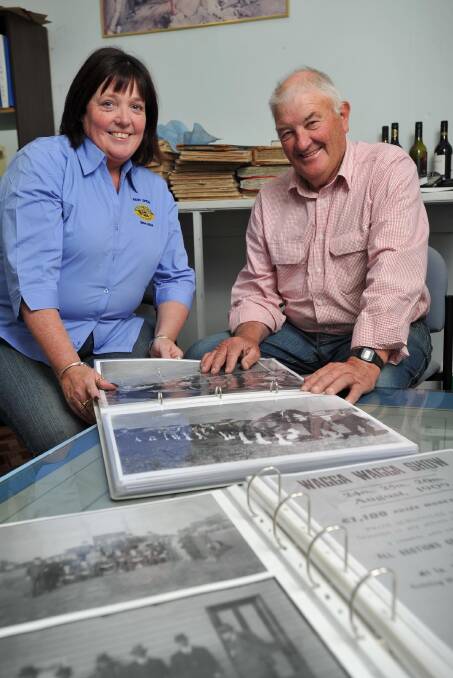 Wagga Show Society secretary Aileen Storey and treasurer John Stewart look over some memorabilia in preparation for the 150th show in October. Picture: Michael Frogley