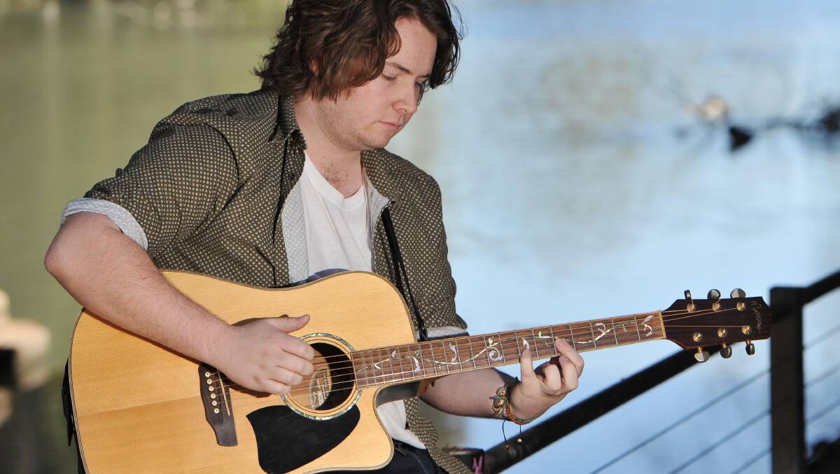 HITTING THE RIGHT NOTES: Wagga born and bred musician, Jarryn Phegan, 18, strums a few chords by the river before a big weekend of performances. Picture: Laura Hardwick