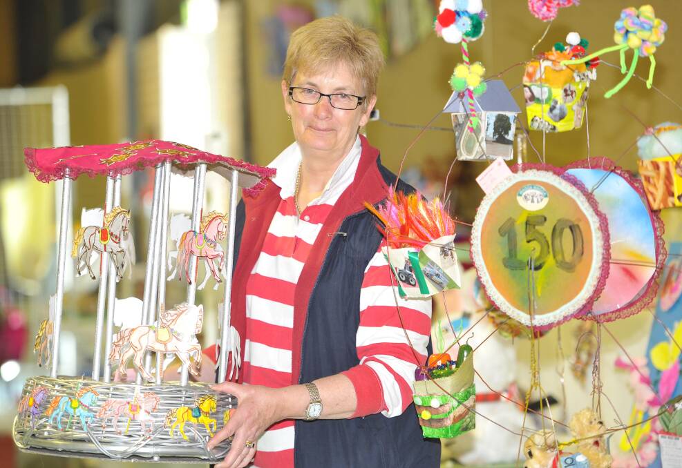 COLOURFUL EXHIBITS: Chief steward of arts and craft Jackie Millward inspects some entries. Picture: Laura Hardwick