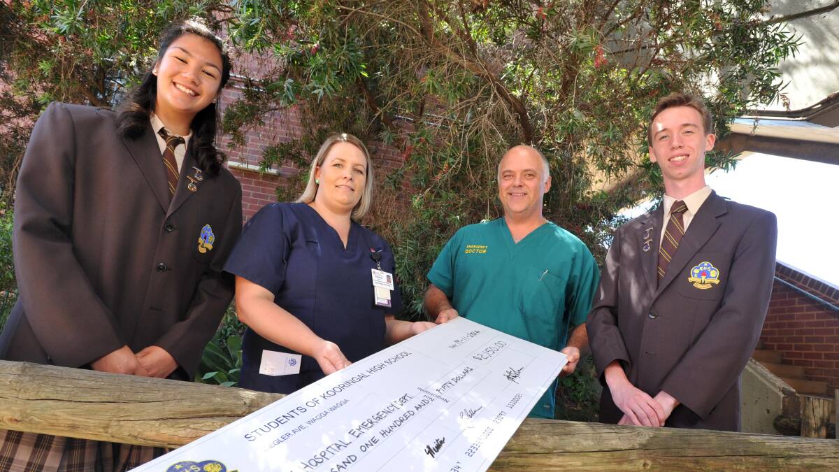 CHEQUE-ING INTO EMERGENCY: Kooringal High School captains (left) Christina Fawns and (right) Sam Bannister present a cheque of $2150 to the Wagga Base Hospital Emergency Department represented by (centre from left) nurse manager Rebecca Bush and staff specialist Dr Andrew Cumberlege, to thank them for helping fellow students who were involved in a tragic car accident. Picture: Michael Frogley