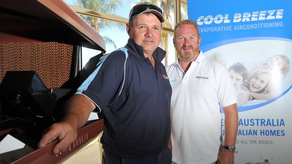 FAMILY BUSSINESSES: Craig Stewart Electrical owner and director Craig Stewart is recognised by Coolbreeze sales manager Bruce Dargavel for his long-term relationship with the company.	 Picture: Laura Hardwick