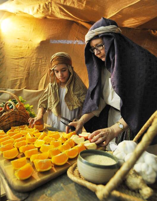 SWEET GIFTS: Shepherds Lachlan Graham, 9, and Julia Papasidero prepare gifts of sweet oranges at Come to Bethlehem. Picture: Kieren L Tilly 