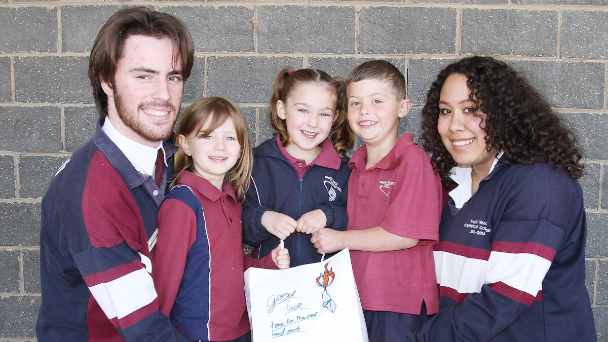 END OF AN ERA: Year 12 Wagga Christian College vice captains David Fletcher and Joy Lili enjoy time with kinder students Jayde Wilksch, 5, Jaime Edelman, 6, and Tye Coughlan, 5, as they celebrate the end of their school life. Picture: Kieren L Tilly