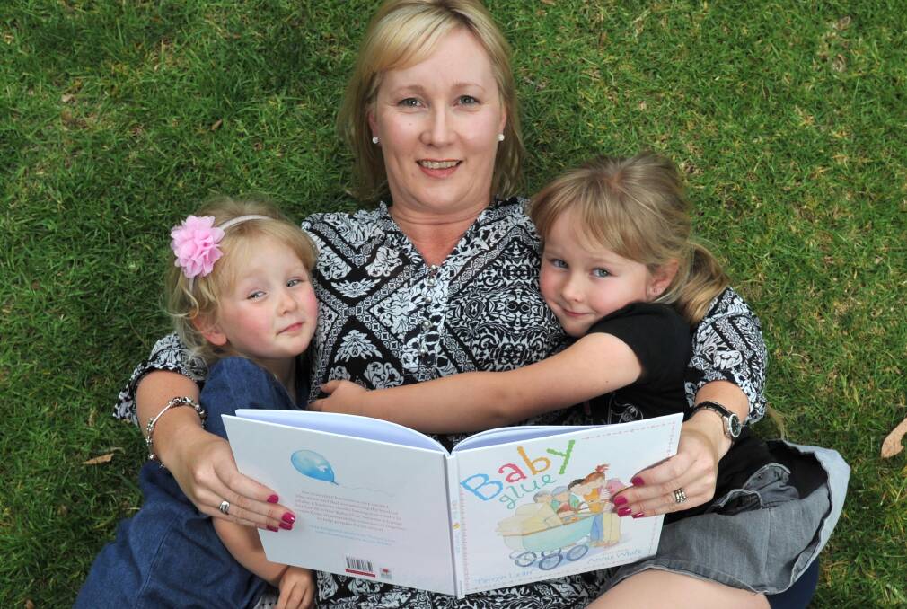 FAMILY TIES: Author Tarryn Lean reads her new book Baby Glue to daughters  Hope, 3, and Faith, 6. Picture: Michael Frogley