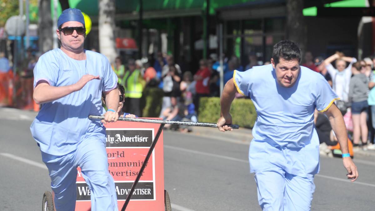 CHARIOTS ON FIRE: Members of the Calvery Hospital team race to the finish line in the 2013 race.