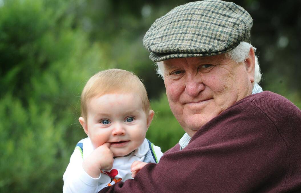 NOT FORGOTTEN: John Flagg, holding his grandson Joshua, will be remembered for his jovial personality and strong character.