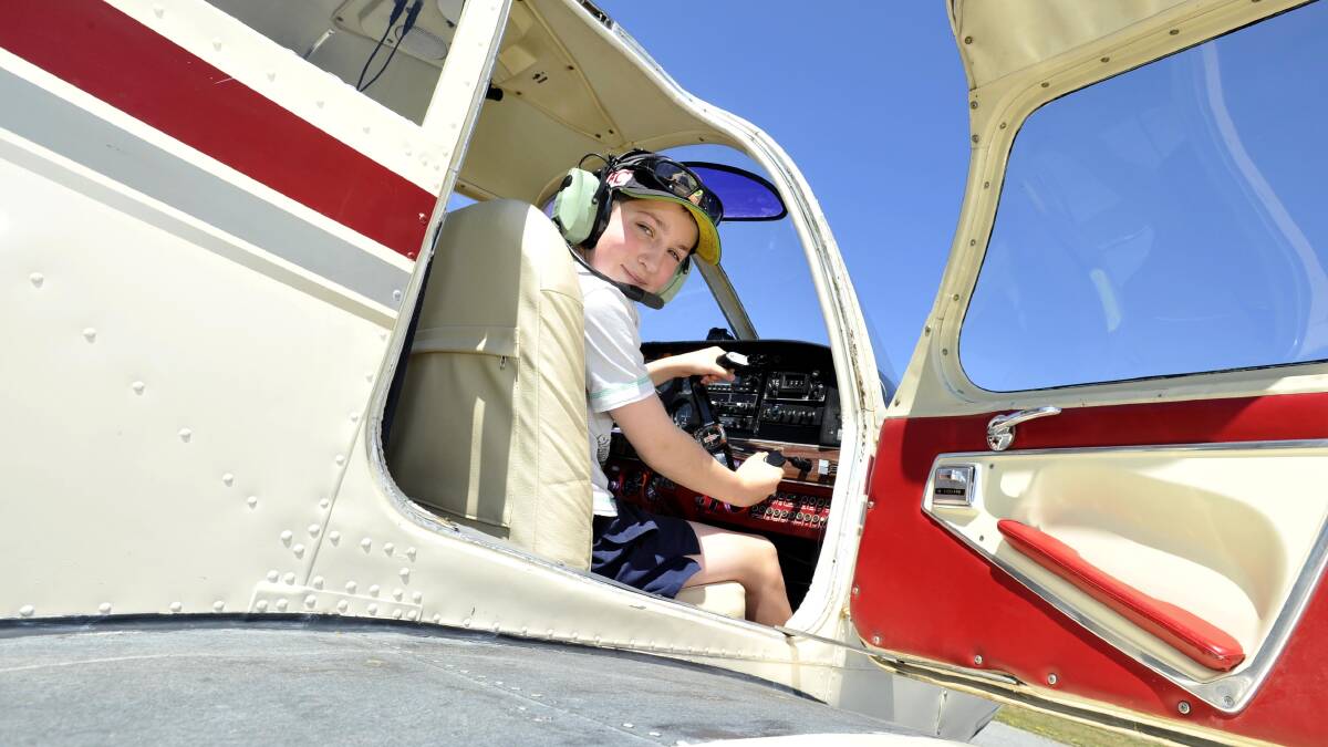 UP AND AWAY: Zach Burton, 13, has the time of his life in the cockpit of a Piper Cherokee Arrow. Picture: Les Smith