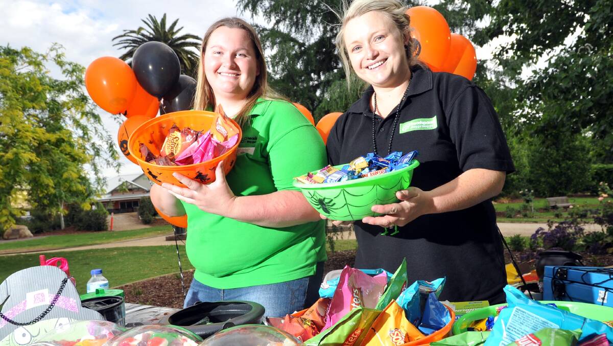 A SWEET NIGHT: Ashley Whicker and Maja Asmus serve up a feast at the headspace Halloween-themed open air trivia night signalling the end of mental health month. 							     Picture: Laura Hardwick