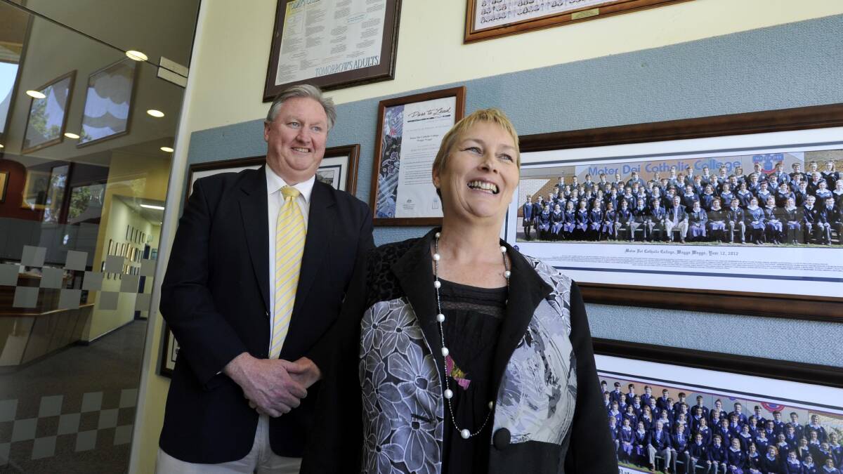 CHANGING GUARD: Mater Dei Catholic College's outgoing principal Greg Miller welcomes 2015 principal Val Thomas to the school. Picture: Les Smith
