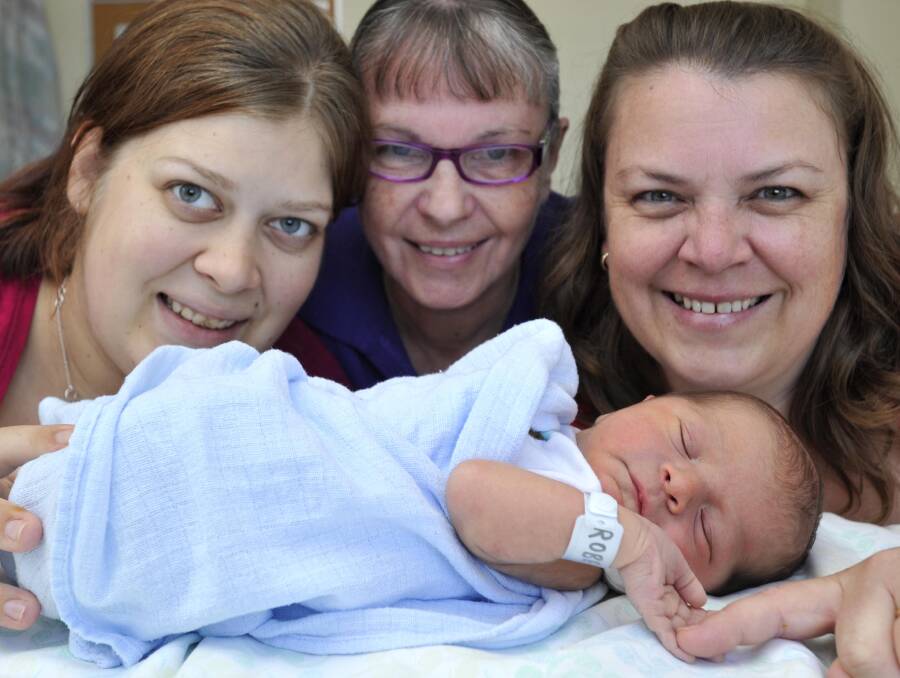 Wagga Base Hospital midwife Mavis Gaff-Smith (centre) delivered her great-grandson Hamish Giovannelli on April 15. Mavis also delivered Hamish's mother - her granddaughter - Hannah Roberts (left) 22 years ago. Hannah, Mavis and Hamish are pictured with Mary-Jo Cutler, Mavis's daughter and Hannah's mother. Picture: Les Smith