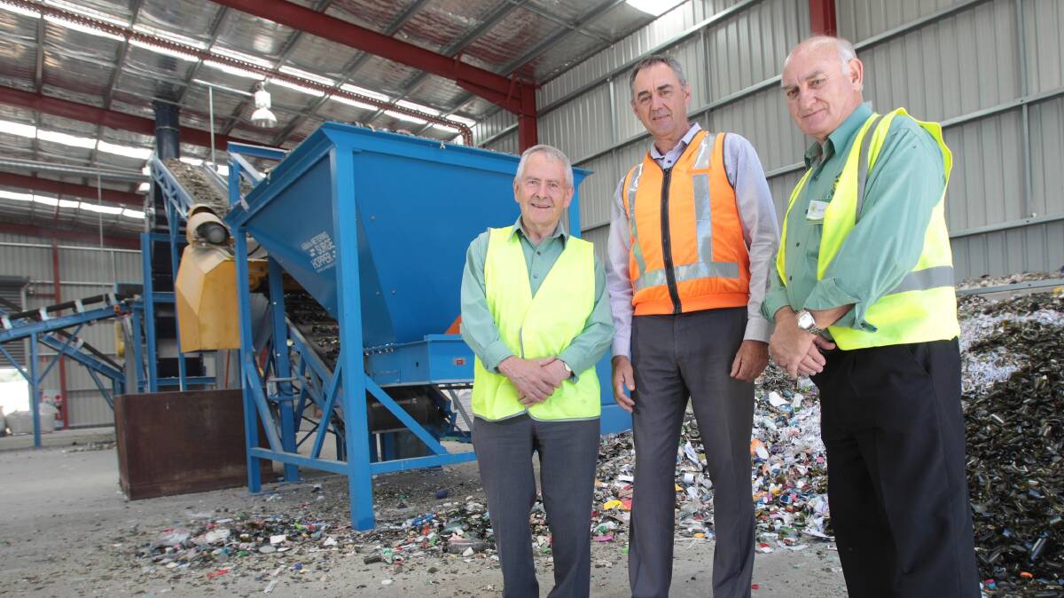 CRACKING RECYCLING PUZZLE: Wagga Tidy Towns sustainable community committee chair John Rumens and secretary (right) Graham Jackaman present Kurrajong Recyclers operations manager Tim Macgillycuddy with a recycling award. Picture: Kieren L Tilly