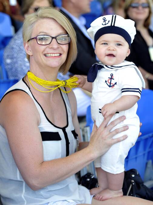 MINI SAILOR: Rebecca O'Connor and niece Queenie O'Connor, 10 months, watch mum Megan McLaughlin graduate. She received the Australian Defence Medal. Picture: Les Smith