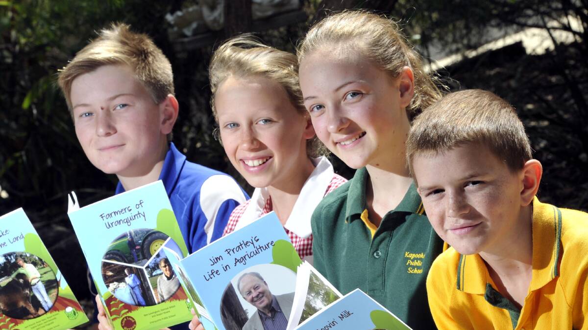 THE STORY OF A HERO: School students (from left) Royce Hunter, 12, Hannah Billett, 11, Lily Wakins, 12, and Cameron McDougall, 11, of Yerong Creek, Uranquinty, Kapooka and Ladysmith Public Schools respectively show off their books, fresh from the press, written about everyday local heroes. Picture: Les Smith