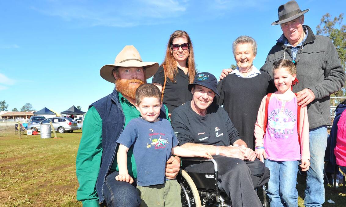 THE BRADLEY FAMILY: Garry Bradley (sitting) was overwhelmed by community support for the Snowy Hydro SouthCare helicopter at the Coolamon Showgrounds over the weekend. Pictured with (from left) brother Scott, son Will, 5, wife Louise, mum Mon, dad Brian and daughter Ally, 8. Picture: Kieren L Tilly