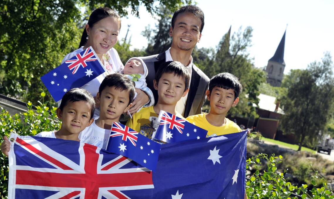 NEWEST AUSSIES: The Nan Hee family, mum Sai Kham with one month old Jeremiah, dad Ti Dang, (front from left) Ah Jong, 5, Ah Dee, 7, Ah Phong, 9 and David Ah Dee, 11, originally from Myanmar, celebrate becoming citizens of Australia. Picture: Les Smith