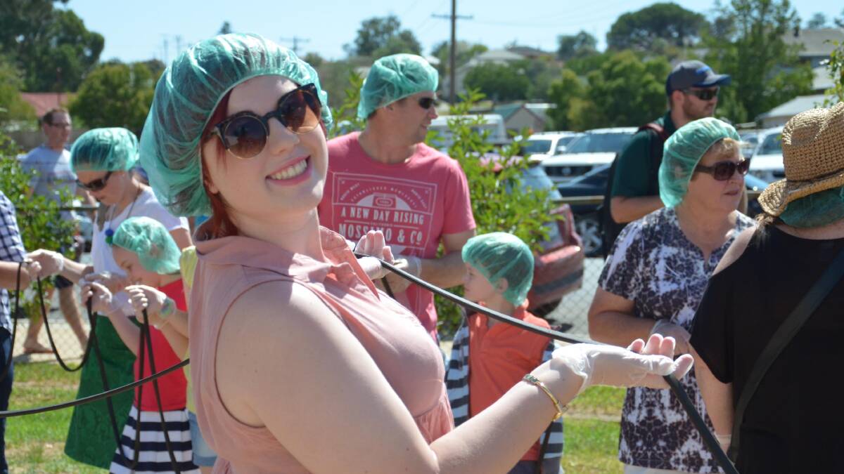 Deanna Maxwell-Price from Junee takes part in the world's longest licorice strap attempt. Picture: Declan Rurenga