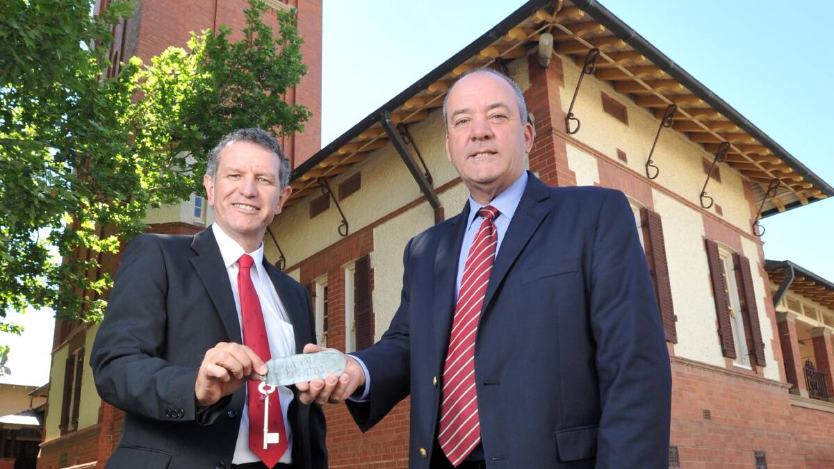 Member for Wagga Daryl Maguire (right) hands the keys to the courthouse over to Project Coordination project manager Denis Cauduro. Picture: Michael Frogley