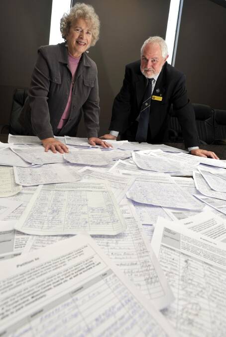 Ronda Lampe looks over a petition, featuring more than 3000 signatures, calling for the relocation of the Visitor Information Centre to its original site with Wagga mayor Rod Kendall. Picture: Les Smith