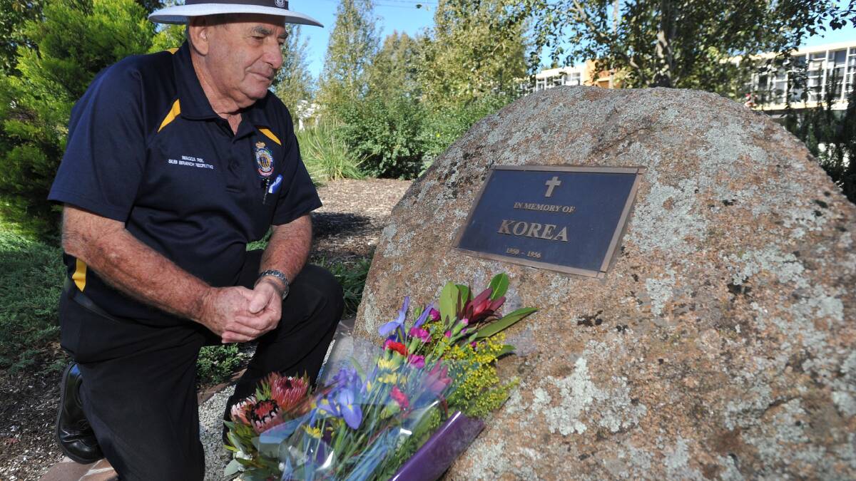 Wagga RSL sub-branch vice president Harry Edmonds lays flowers as he reflects on his time serving in the Korean War. Picture: Laura Hardwick
