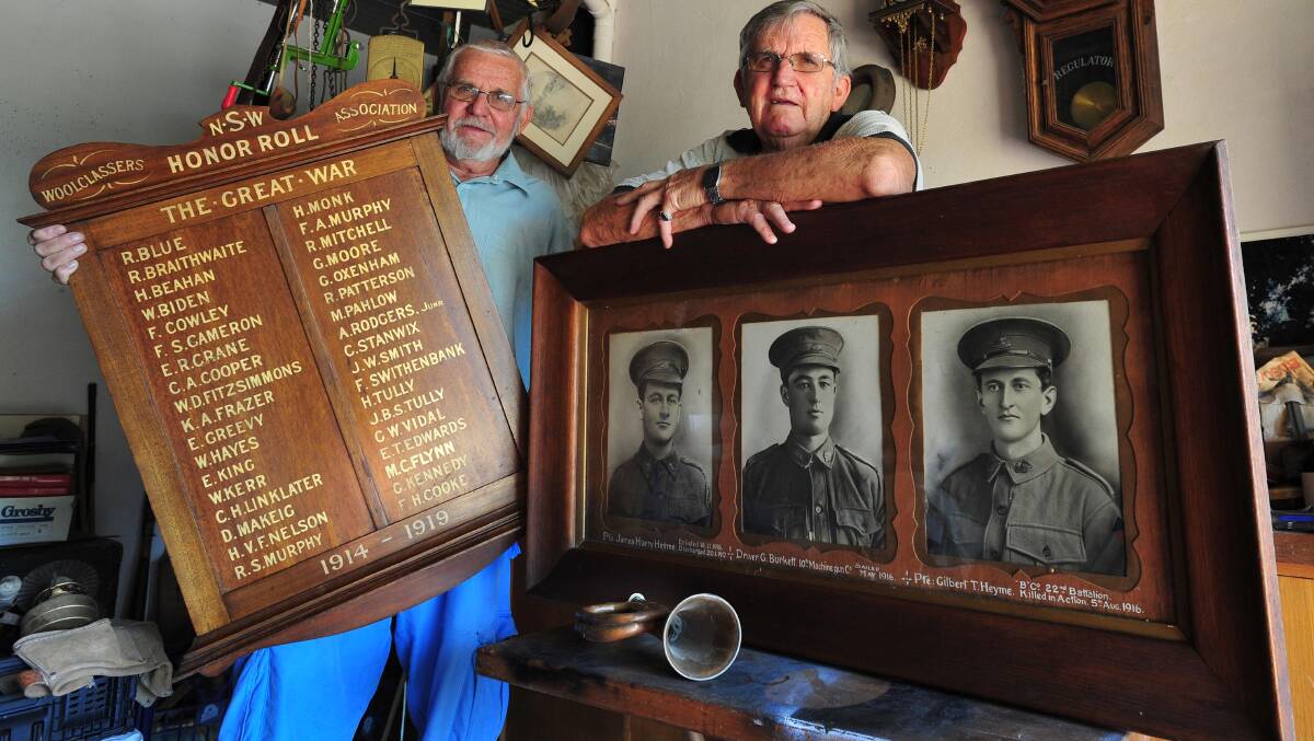 Jack Whyte (left) and his brother Terry with the framed photographs of three World War I soldiers and a woolclassers NSW roll of honour. Picture: Kieren L Tilly