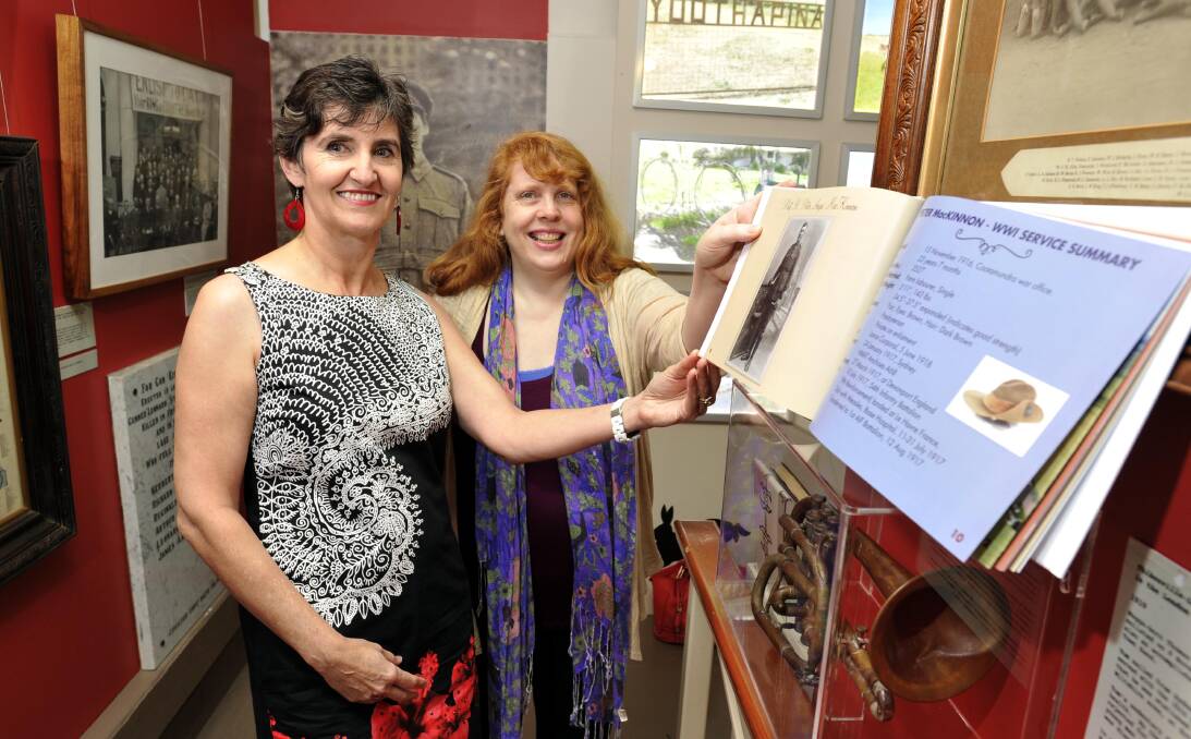 FAMILY TREASURE: Michele Hemmings (left) and her book with Museum of the Riverina curator Michelle Maddison. Picture: Les Smith
