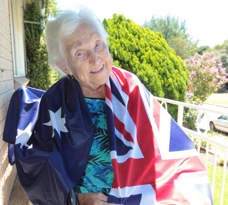 FAIR DINKUM: Corry Van Duuren is all smiles draped in her new Australian flag. Picture: Kieren L Tilly