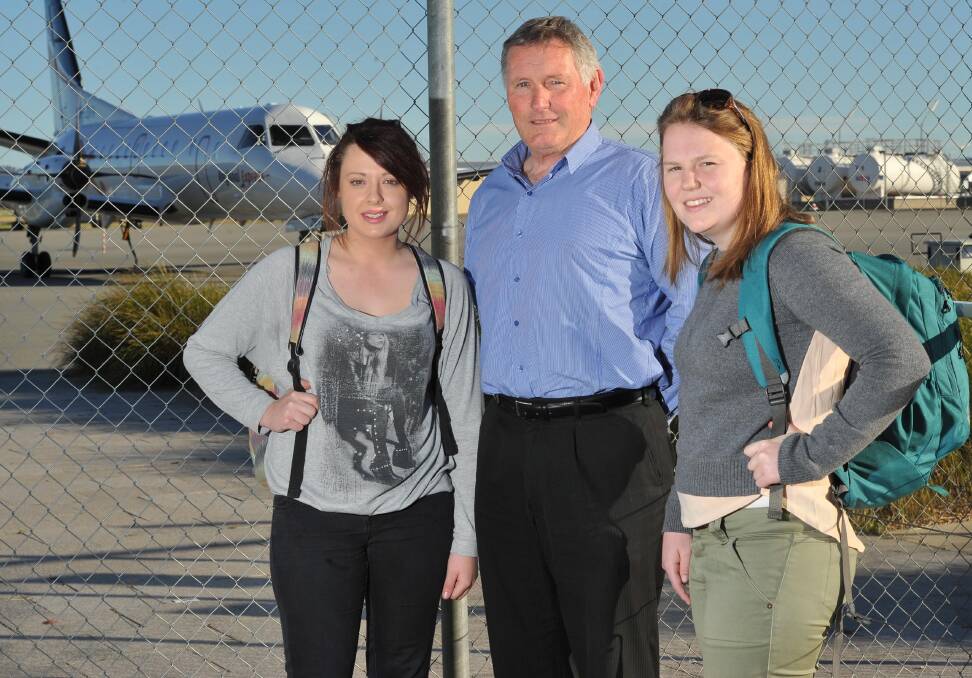 KOKODA BOUND: Courtney Smith (left) and Laura Kane are farewelled at the Wagga airport by RSL Club business manager Terry Williams. Picture: Laura Hardwick