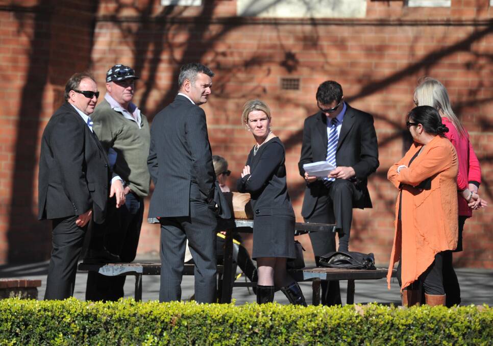 BOAT DRIVER: Robert Richards (third from left) outside the Wagga court house. Picture: Michael Frogley