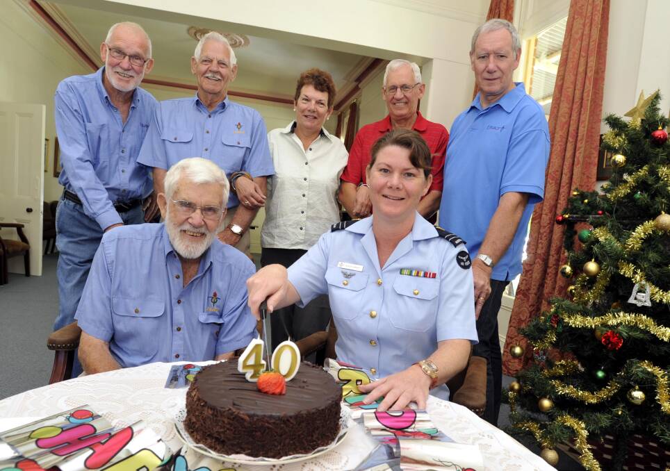 GREAT GIFT: Helping Evelyn Wright celebrate her 40th birthday at Legacy House are Gerry Shilling (seated next to Evelyn) and, from left, Peter Heard, Norm Alexander, Helen Nixon, Doug Conkey and Phillip Tome. Picture: Les Smith