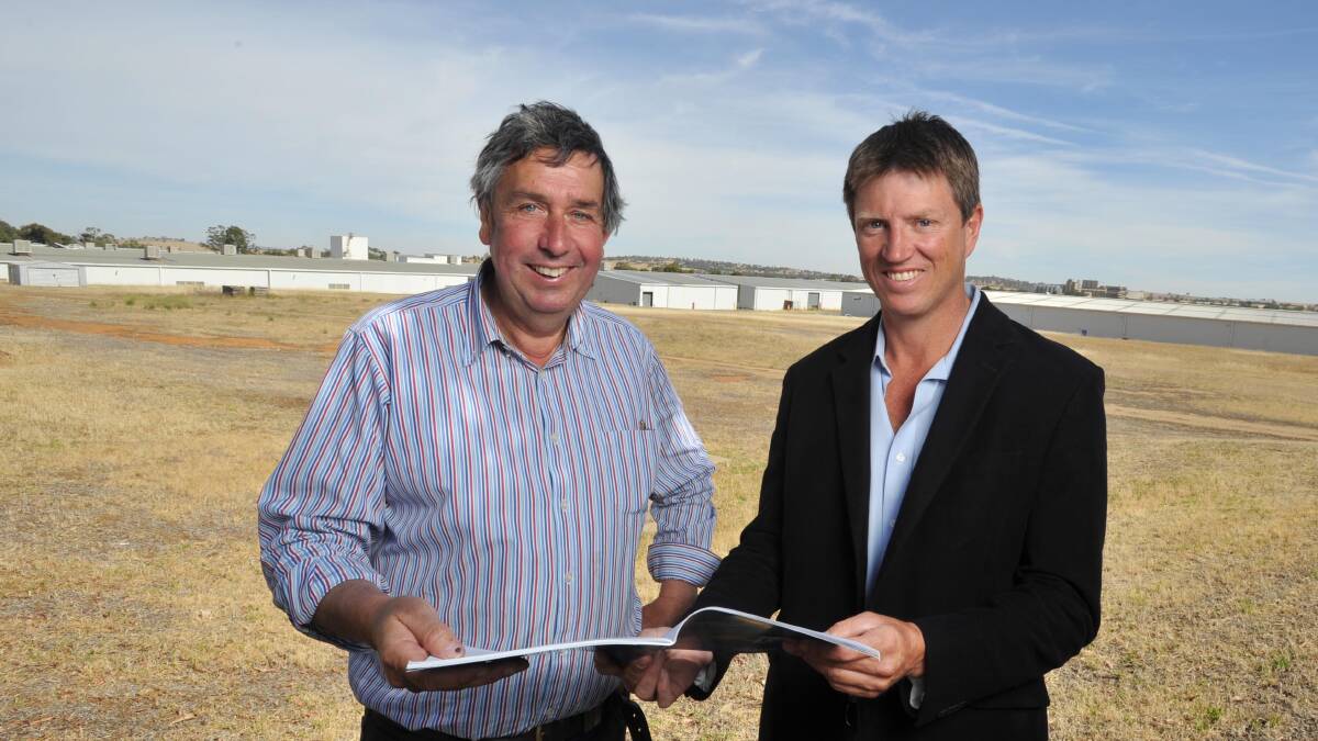 SOLD: Charlie Bannatyne (left) and Chris Egan of Riverina Sustainability Centre with some of the former Riverina Wool Combing buildings in the background. Picture: Michael Frogley