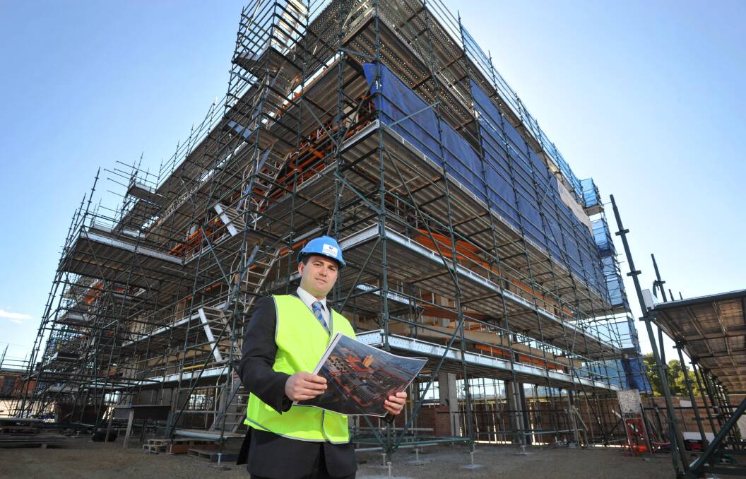 UP, UP AND AWAY: Joshua Eldridge is dwarfed by The Mill's building one. Picture: Michael Frogley