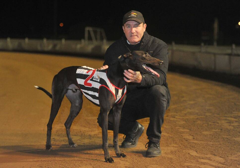 Victorian trainer Michael Carter with greyhound Jimmy Lane after winning the 2013 Wagga Gold Cup.