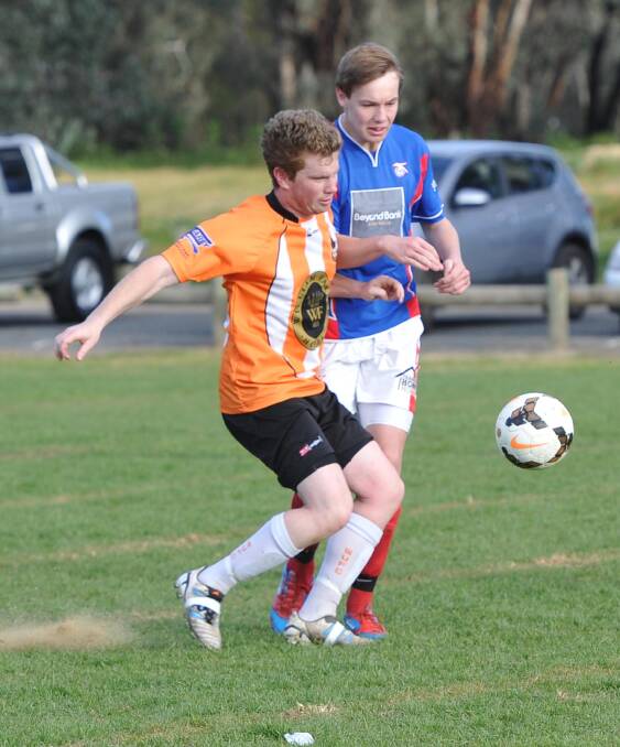 Wagga United debutante Mitch Davis and Henwood Park opponent Jake Ploenges compete for possession at Rawlings Park.