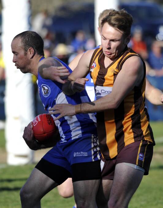 Temora captain Chris Block is bundled over the sideline by EWK's Scott Burge during the semi final at Maher Oval. Pictures: Les Smith