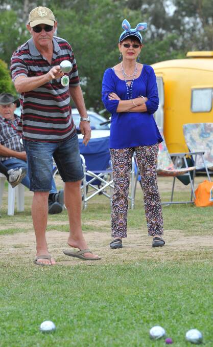 Gary Abbott, of the Gold Coast sends down a ball in a petanque game as Lismore's Helen Bailey watches on at the Stone the Crows Festival. Picture: Kieren L Tilly