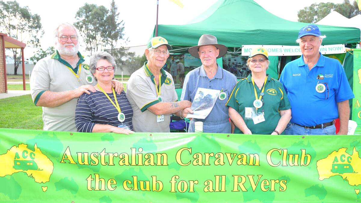 John Reynolds (fourth from left), of Iluka via Grafton, becomes the newest member of the Australian Caravan Club at the Stone the Crows Festival. He is congratulated by fellow caravan afficianados (from left) Alex and Dot Mark, from Meadow Creek in Victoria, Bill and Una Taylor, from Wagga, and Royce Woodhouse from Perth. Picture: Kieren L Tilly