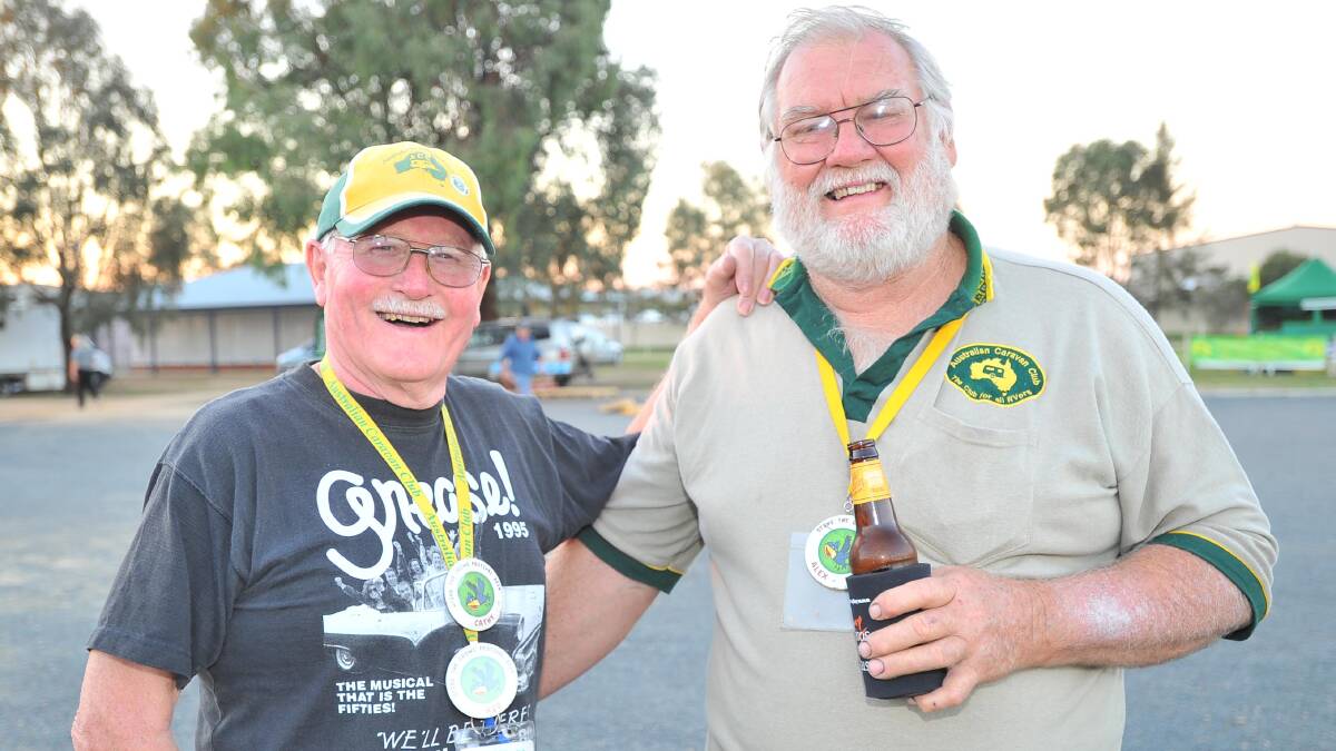 Australian Caravan Club members Bob Farrington, from Avalon in Victoria, and Alex Mark, from Meadow Creek, via Wangaratta meet up for a drink at the Stone the Crows Festival on Thursday. Picture: Kieren L Tilly