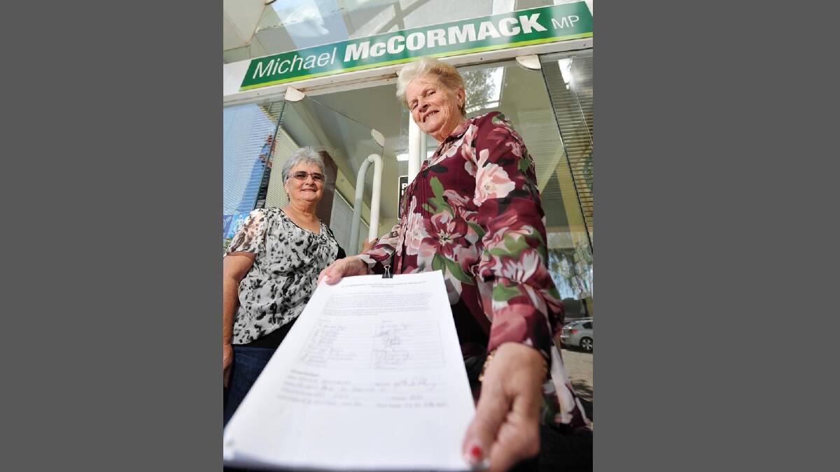 Wantabadgery resident Maggie Salisbury hands over a petition to Michael McCormack's office to get internet/phone services to Wantabadgery (left) Gail Ryan (friend/moral support) and Maggie Salisbury with petition in hand.