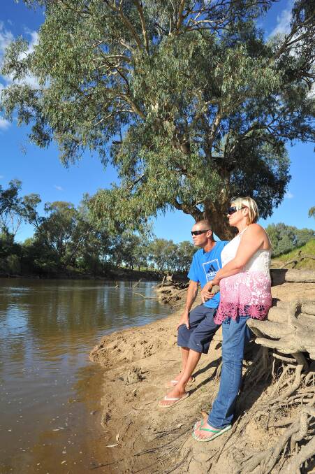 HEARTBREAK: Darren Little and Michelle McFeeters at the Murrumbidgee River yesterday as the search for their 23-year-old son Brent continues. Picture: Kieren L Tilly