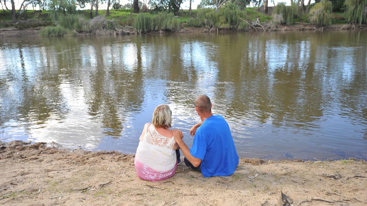 HEARTBREAK: Darren Little and Michelle McFeeters at the Murrumbidgee River yesterday as the search for their 23-year-old son Brent continues. Picture: Kieren L Tilly
