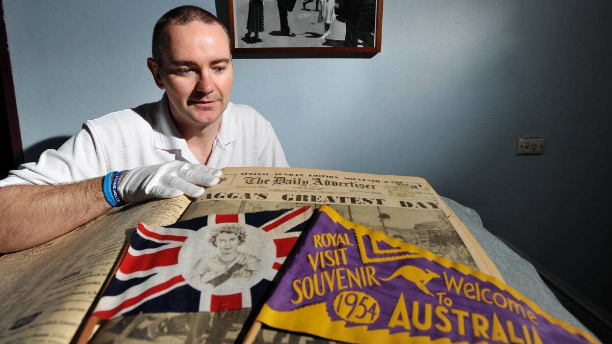 CSU Regional Archives manager Wayne Doubleday pores over the papers and souvenirs from the Queen's 1954 visit to Wagga. Picture: Alastair Brook