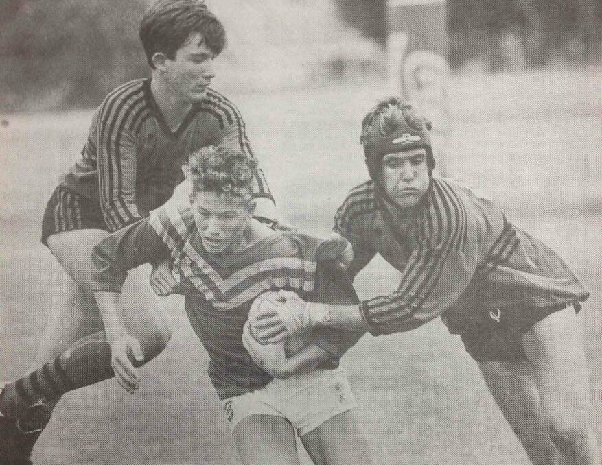Yanco Ag High halfback John Jones wrestles to break away from West Wyalong High School defenders Brett Ridley and Bill Gray in the first Commonwealth Bank Cup game. Jones was one of Yanco's best players in his side's 54-8 triumph.